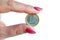 Euro coin in fingers