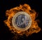 Euro coin with fire flames.