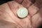 Euro coin on a man\'s palm