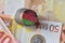 Euro coin with national flag of malawi on the euro money banknotes background.