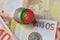 Euro coin with national flag of portugal on the euro money banknotes background.