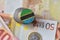 Euro coin with national flag of tanzania on the euro money banknotes background.