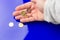 Euro coins in the hand of an adult person, on colored background