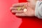 Euro coins in the hand of an adult person, on colored background