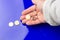 Euro coins in the hand of an adult person, on colored background