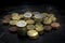 Euro coins with high contrast and bright lighting seen from above with a black background