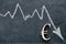 euro currency rate. Euro inflation.Euro sign and a down arrow on a black background. Financial Crisis.Euro currency