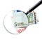 The euro currency under a magnifying glass