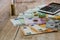 Euro, dollars, cents and calculator spread out on a wooden background