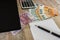 Euro, notebook, calculator and part of the laptop on a wooden background