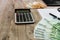 Euro, notebook, calculator and part of the laptop on a wooden background