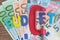 Europe finance, economic, money squeezing idea, colorful alphabet word BUDGET using red clamp as G letter on Euro banknotes on