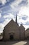 Europe, France. Small Gothic Church. Easter Morning with the Sun Behind the Church Cross