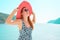 Europe Greece travel vacation. Woman enjoying seaside sunny weather. Young lady living fancy lifestyle wearing red hat on holidays