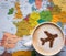 Europe map and cup of coffee (airplane made of cinnamon)