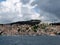 Europe. Meditarranean area. Croatia country. Adriatic sea. Dalmatian riviera. Dry cargo ship. Panorama seaside litle town. Spring