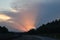 Europe, Slovenia rural road with clouds and sun rays over the sky