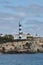 Europe, Spain, Balearic Islands, Mallorca. Porto Colom. Walkway along the waterfront. lighthouse