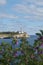 Europe, Spain, Balearic Islands, Mallorca. Porto Colom. Walkway along the waterfront. lighthouse