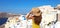 Europe tourist travel woman panorama banner from Oia, Santorini, Greece. Fashion young woman looking at famous blue dome church