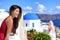 Europe travel cruise destination Santorini woman at Oia tourist landmark attraction, the blue domed church. Happy Asian girl