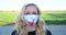 European blond woman wearing original hand made painted face mask during corona virus pandemic
