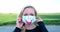 European blond woman wearing original hand made painted face mask during corona virus pandemic