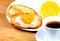 European breakfast: cup of coffee, toasts with jam and orange