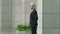 European businessman walking standing looking around thinking