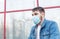 European coronavirus. Portrait of caucasian man wearing facial hygienic mask, respiratory protection mask outdoors. Virus,