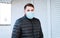 European coronavirus. Portrait of caucasian man wearing facial hygienic mask, respiratory protection mask outdoors. Virus,