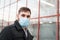 European coronavirus. Portrait of caucasian man wearing facial hygienic mask, respiratory protection mask outdoors. Virus,