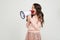 European cute smiling teenager girl with a megaphone reports the news with a megaphone in hands on a white studio