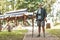 European elderly pensioner and tourist with a stick stands against the background of a Buddhist temple. Religious pilgrimage to