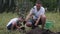 European father and son are planting a plum tree together