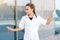 European girl chemist in a white coat with two flasks of blue and red liquids