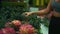 European girl chooses organic fruits in a store holding a pineapple in her hand