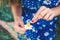 European girl holds a daisy flower and tears off the petals