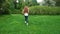 European girl with long curly hair running in the park with soap bubbles. Very long hair fluttering in the wind, slow