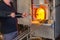 European glass blowing artist making product under high temperature flame