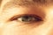 European guy`s eye close up. part of the face macro. the eyeball is extremely close. Human pupil