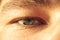 European guy`s eye close up. part of the face macro. the eyeball is extremely close. Human pupil