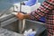 European hake cleaning in a fish shop under the tap.