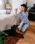 European hipster woman trains dog in her home. dog training, owner-animal communication