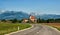 The European landscape where the road leads to the Church building on a background of mountains of Slovenia in Sunny