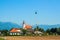 The European landscape where the road leads to the Church building on a background of mountains of Slovenia in Sunny cloudless day