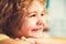 European little school-age boy with brown eyes looking directly at the camera, close-up.