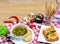 European lunch - vegetables soup, lasagna and dessert served on a wooden table. Italian food background with a copy space/