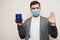 European man in formal wear and face mask, show Belarus passport with stop sign hand. Coronavirus lockdown in Europe country