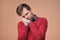 European man in red sweaer being tired standing over brown background.